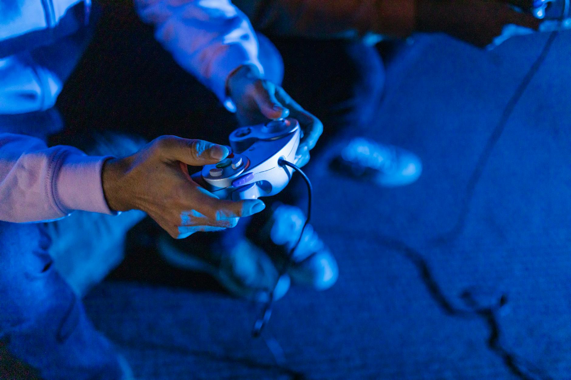 Hands holding a gaming controller during gameplay session