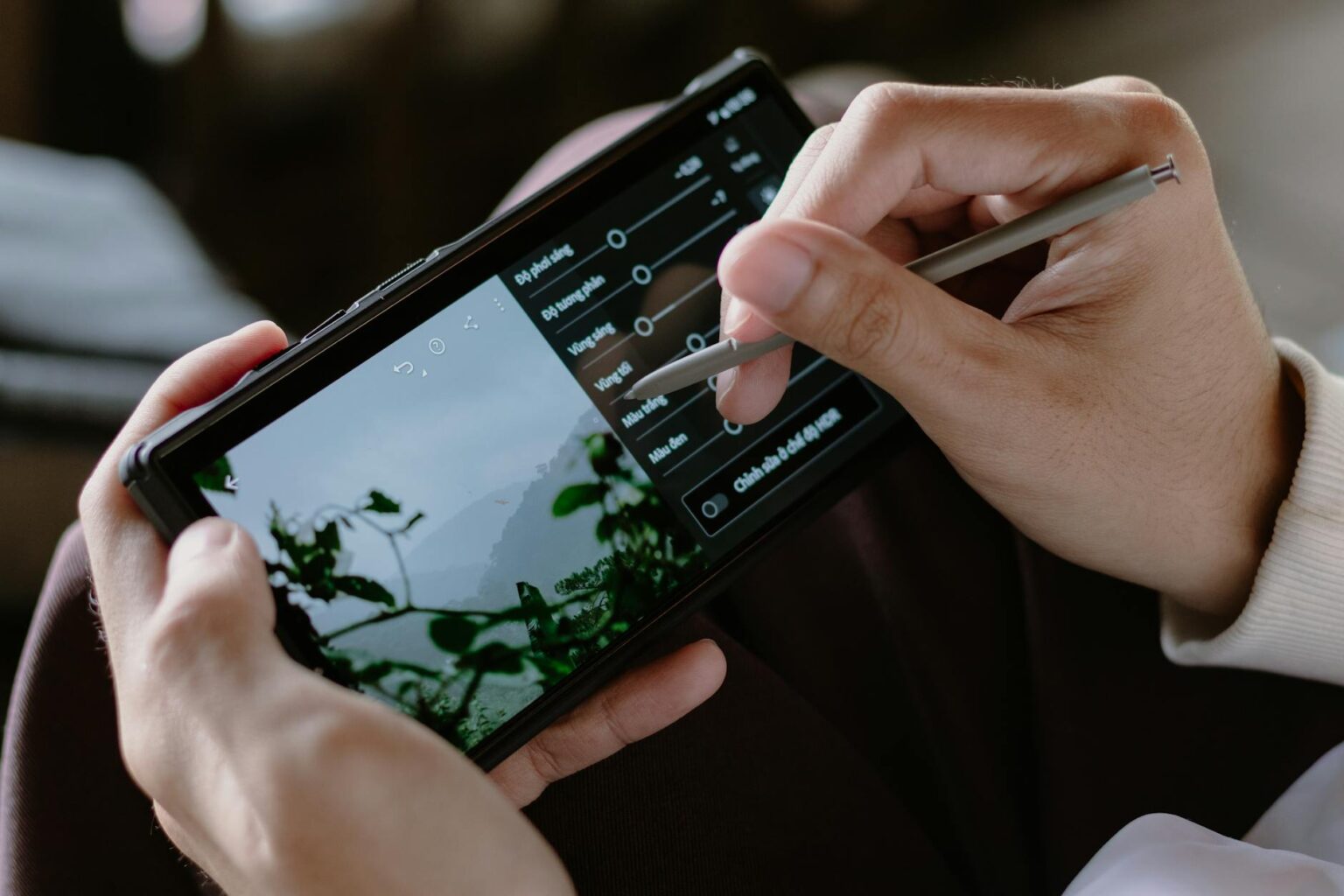 Person using digital stylus on smartphone screen for note-taking