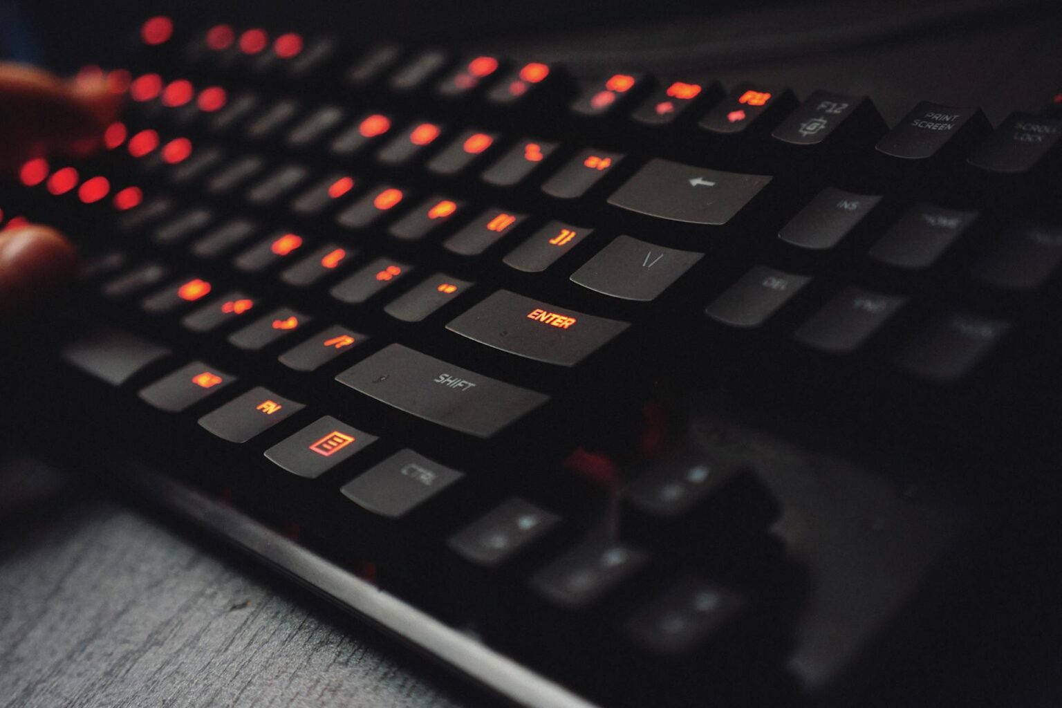 Close-up of a mechanical gaming keyboard with RGB lighting and custom keycaps