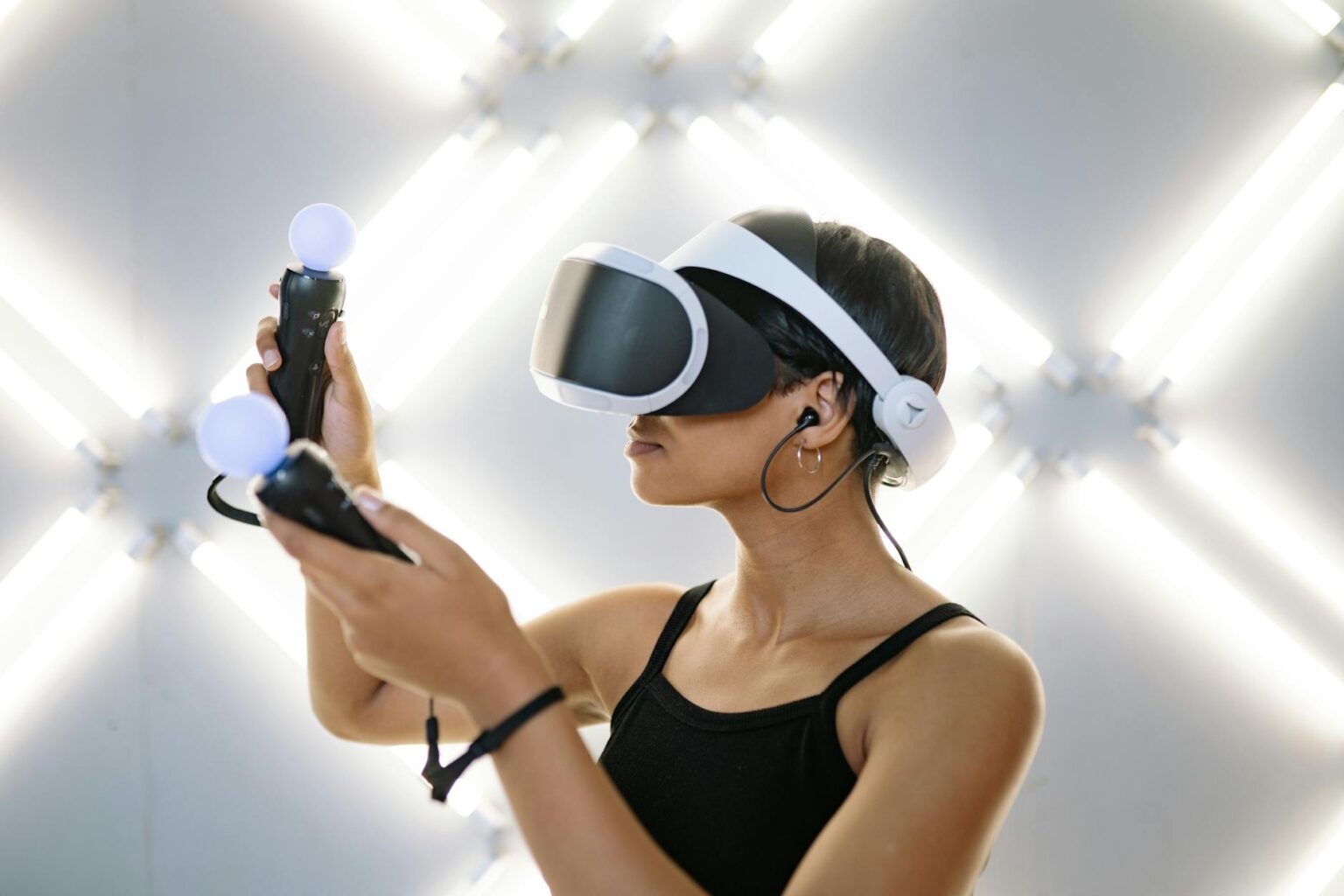 Person wearing virtual reality headset while gaming, hands positioned for interaction