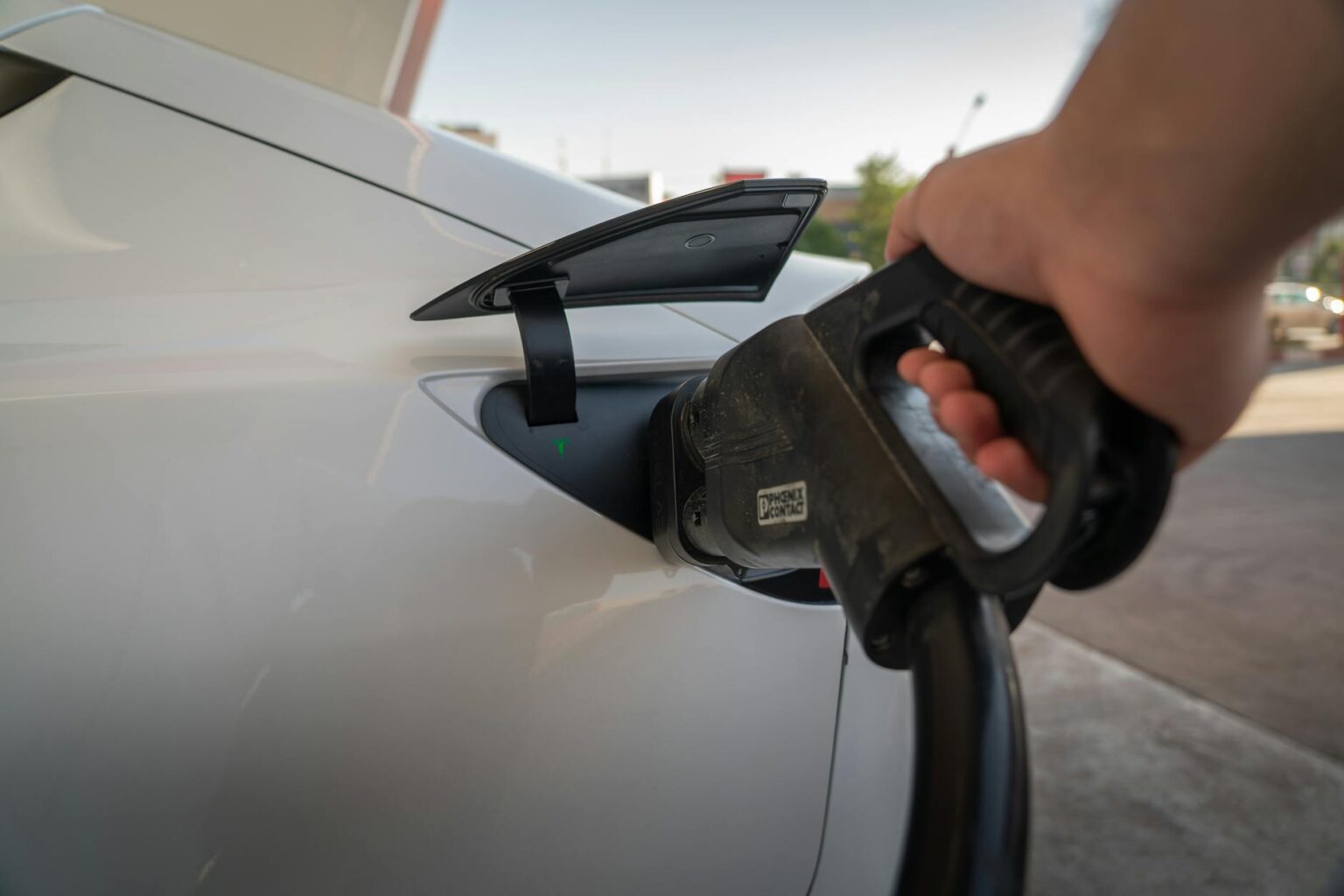 How Electric Vehicle Charging Cables Are Getting Wireless Power Transfer Electric vehicle connected to charging station with cable
