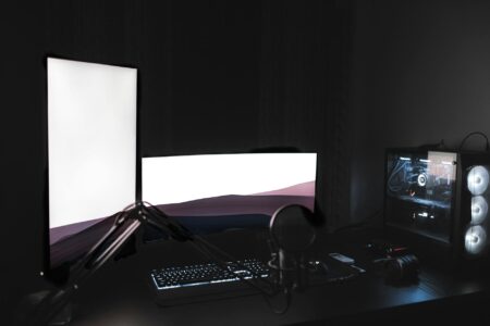 Professional computer streaming setup with multiple monitors and broadcasting equipment