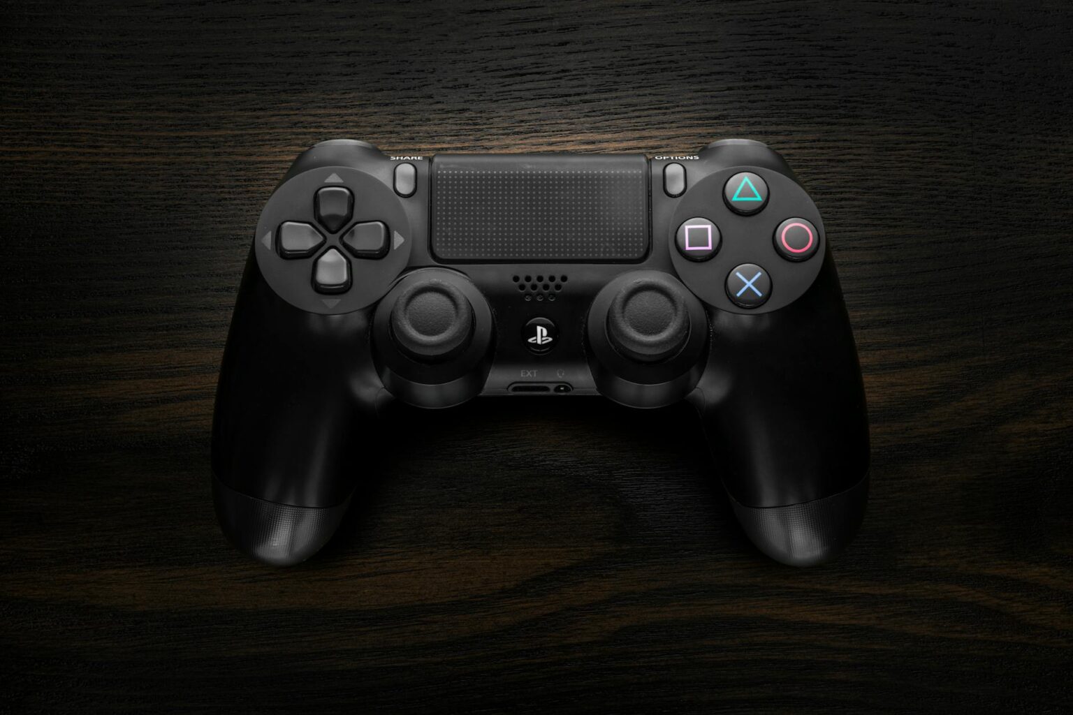 How PlayStation’s Accessibility Controller Is Changing Competitive Gaming Close-up of a gaming controller on a dark surface showing buttons and analog sticks