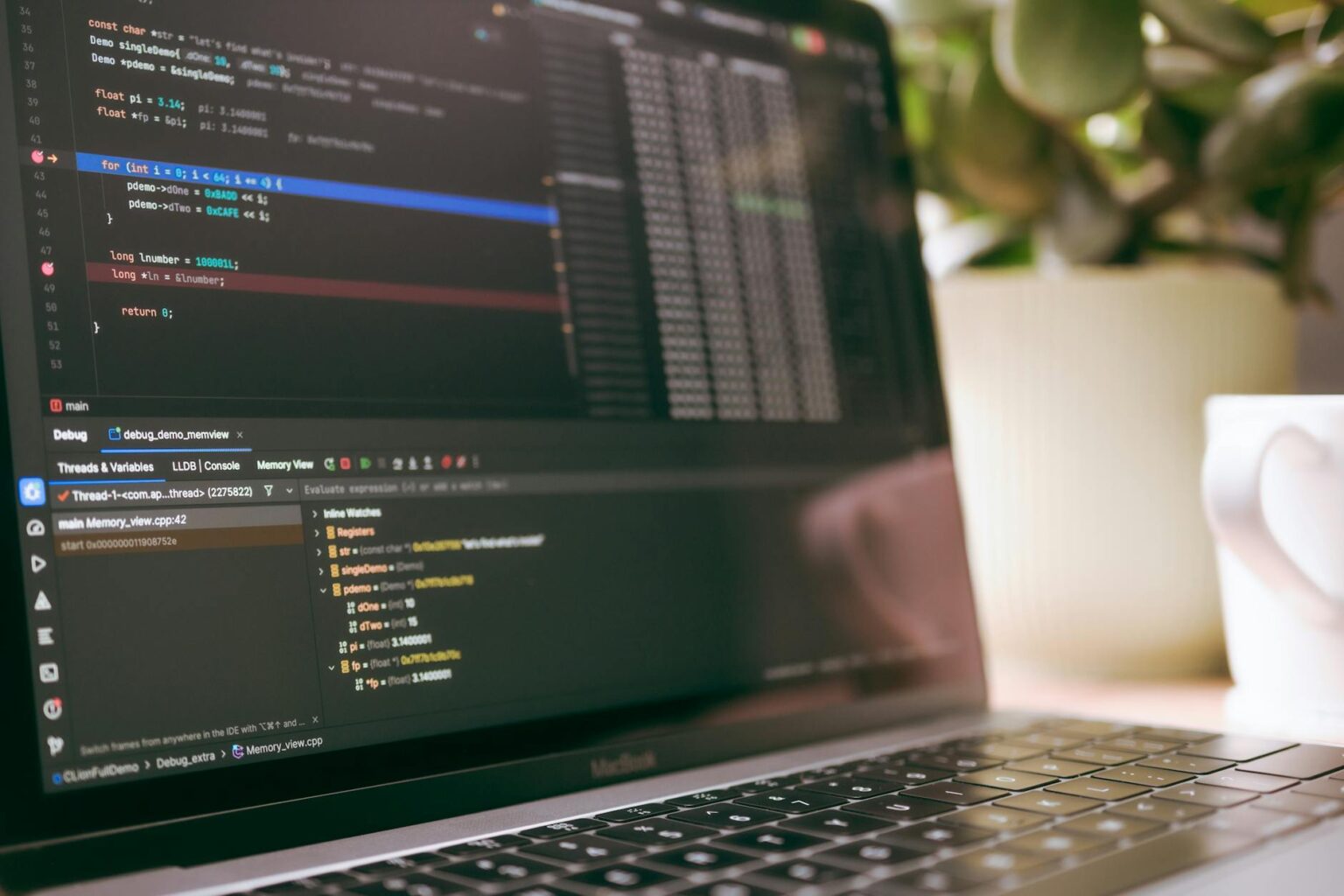 How Browser-Based Development Environments Are Replacing Local Code Editors Developer working on laptop with code editor displaying programming interface