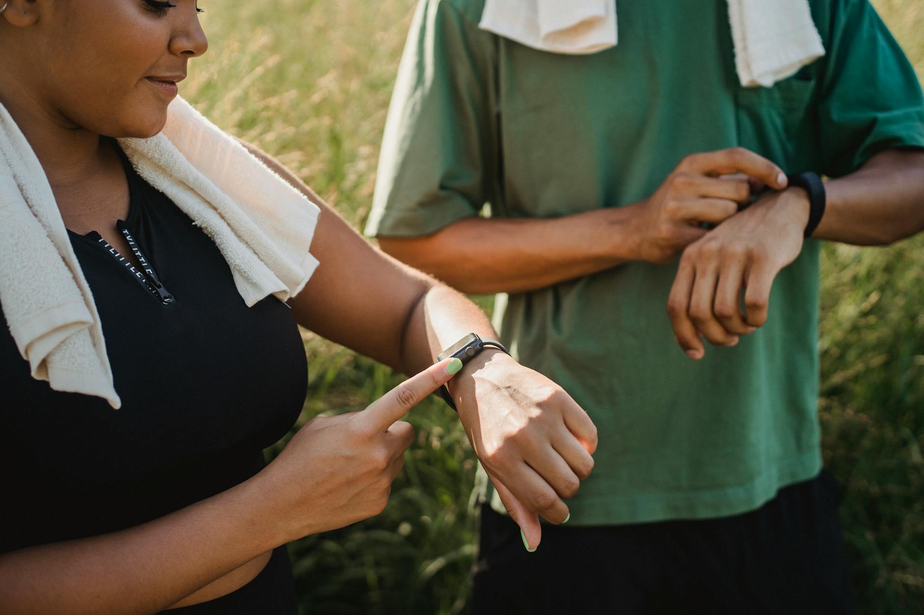 Person wearing a black fitness tracker on their wrist displaying health metrics