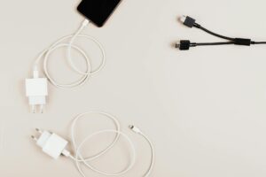 Why Flagship Phones Are Dropping Wireless Charging for Faster Wired Solutions Modern smartphone connected to fast charging cable on desk