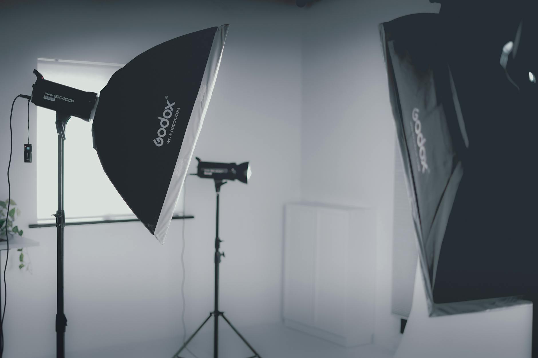 Professional photography studio with multiple lighting equipment and camera setup for commercial shoots