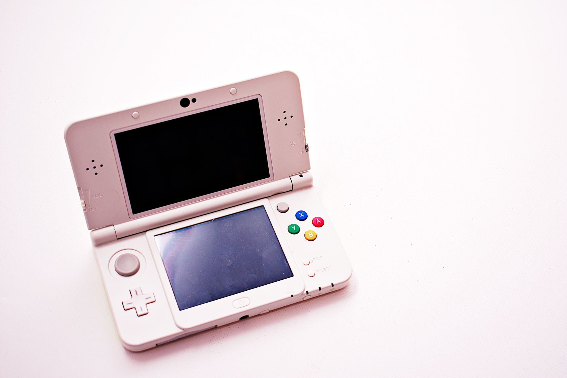 Person holding a handheld gaming console while relaxing on a couch