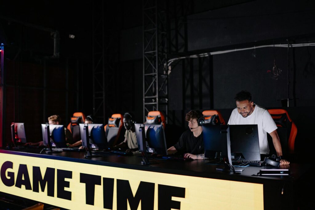 Multiple gaming monitors showing team-based multiplayer games in a PC gaming setup
