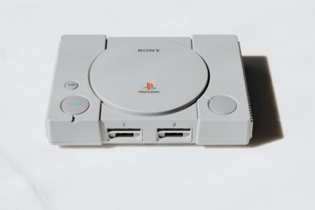 Modern gaming console with controller on entertainment center