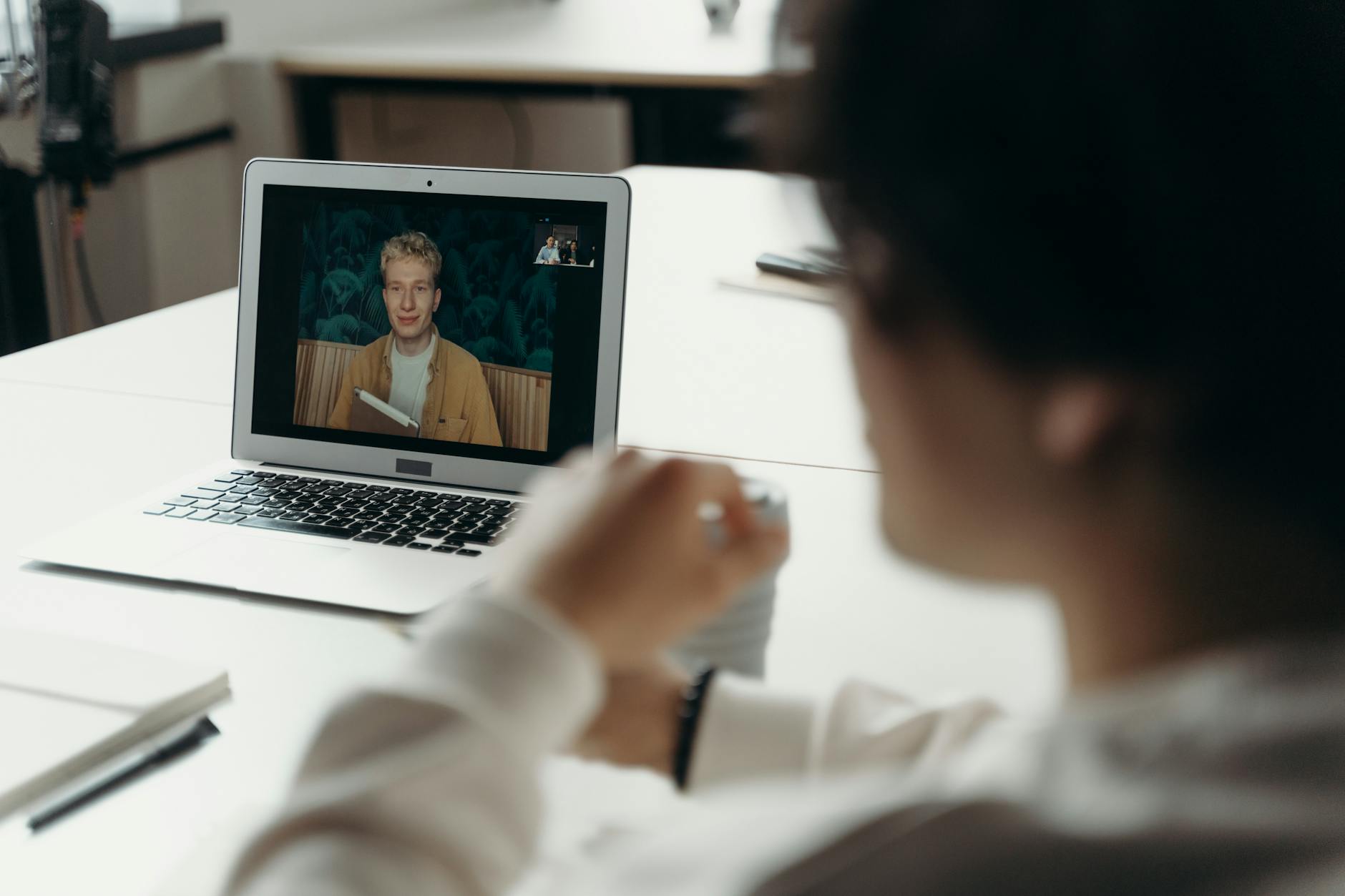 People participating in remote video conference call on laptop screen