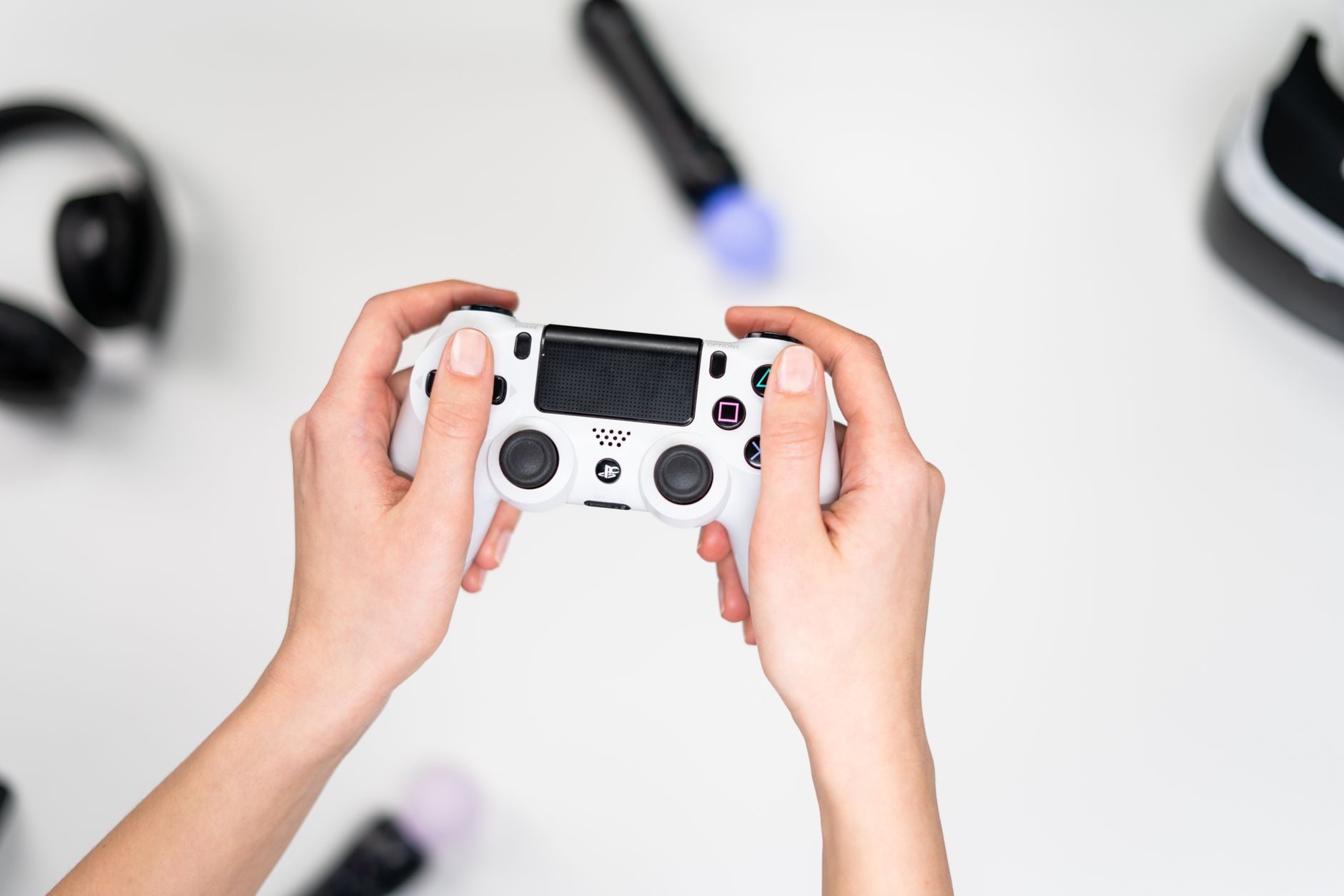 A person playing a portable gaming console on a couch