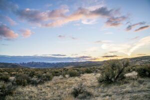 Wide open western landscape at sunset, evoking the setting of Red Dead Redemption 2