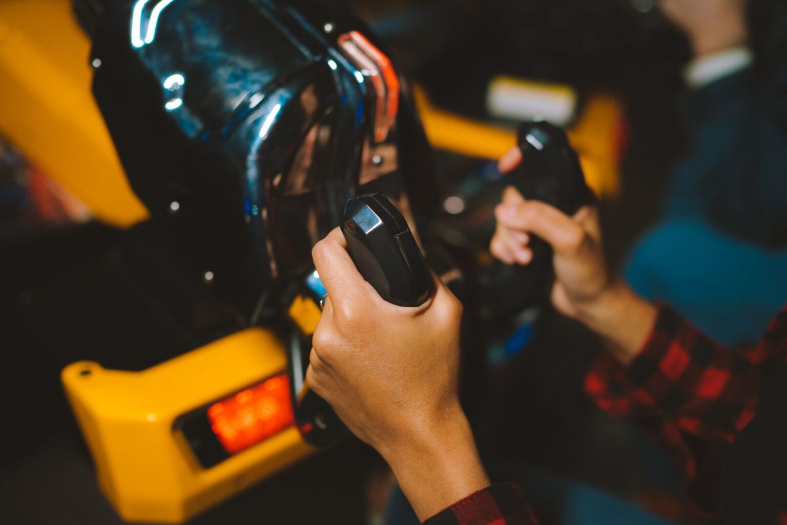 Close-up of a gaming controller with a racing game on screen in the background