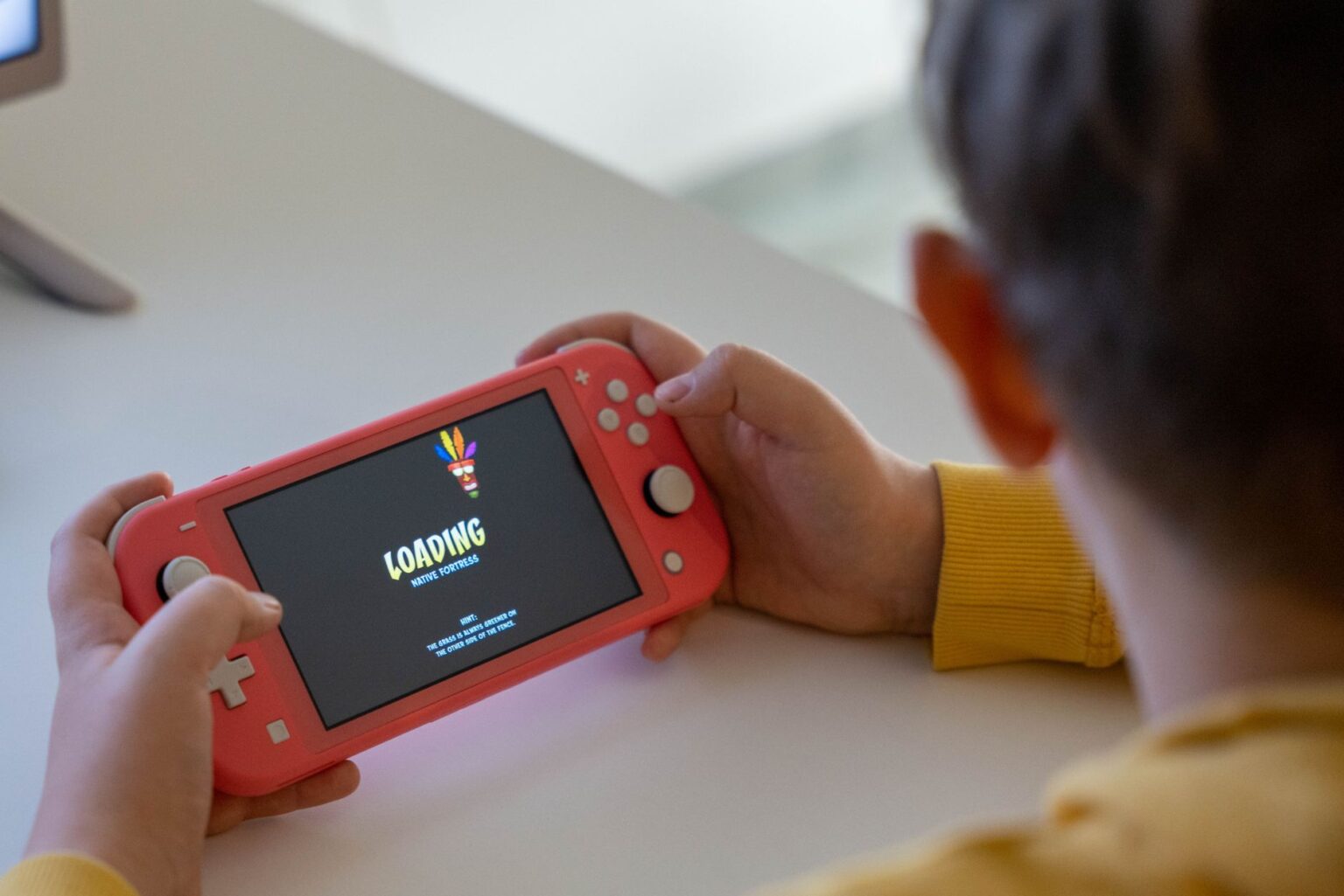 A handheld gaming device resting on a surface, representing portable gaming history