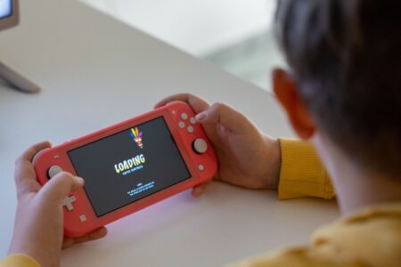 A handheld gaming device resting on a surface, representing portable gaming history