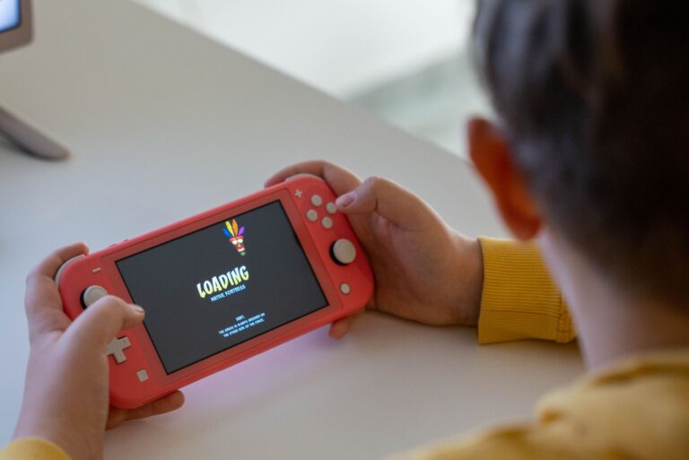 A handheld gaming device resting on a surface, representing portable gaming history