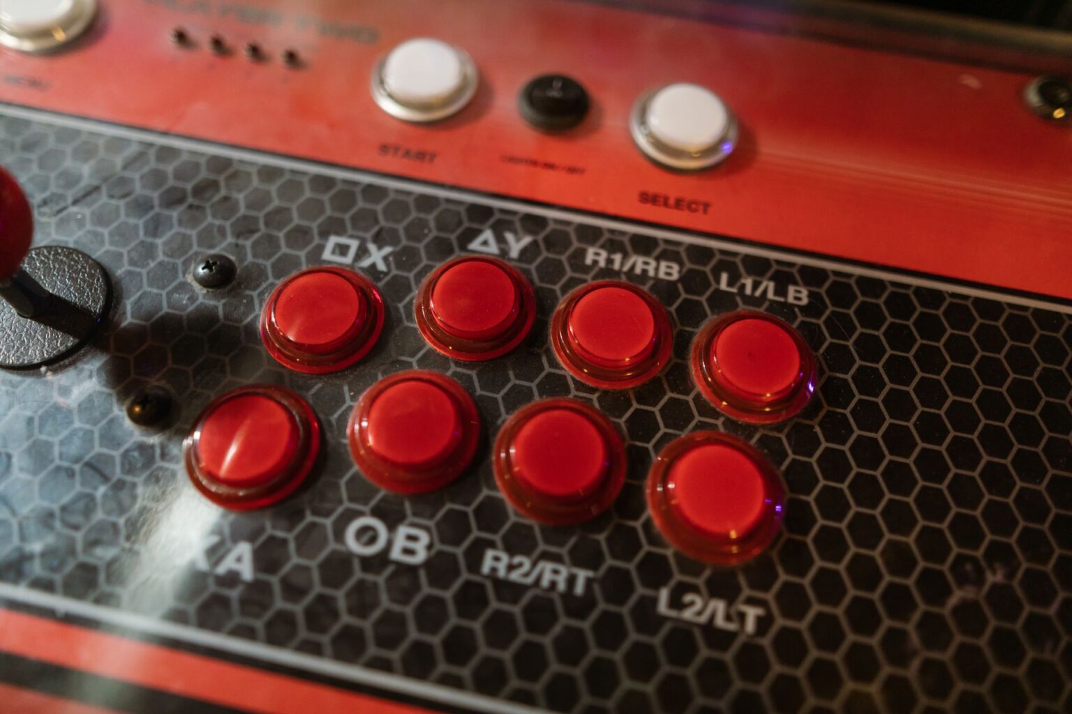 A fighting game arcade cabinet lit up in a dark gaming venue