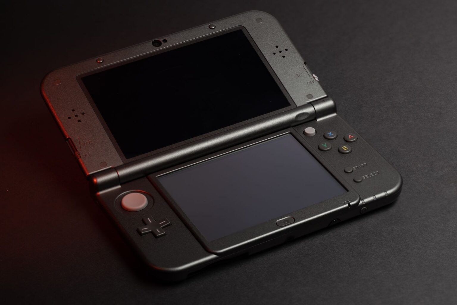 Valve’s Steam Deck 2 Silence Is Stalling Handheld PC Upgrades A handheld gaming PC resting on a desk, representing the current state of portable gaming hardware