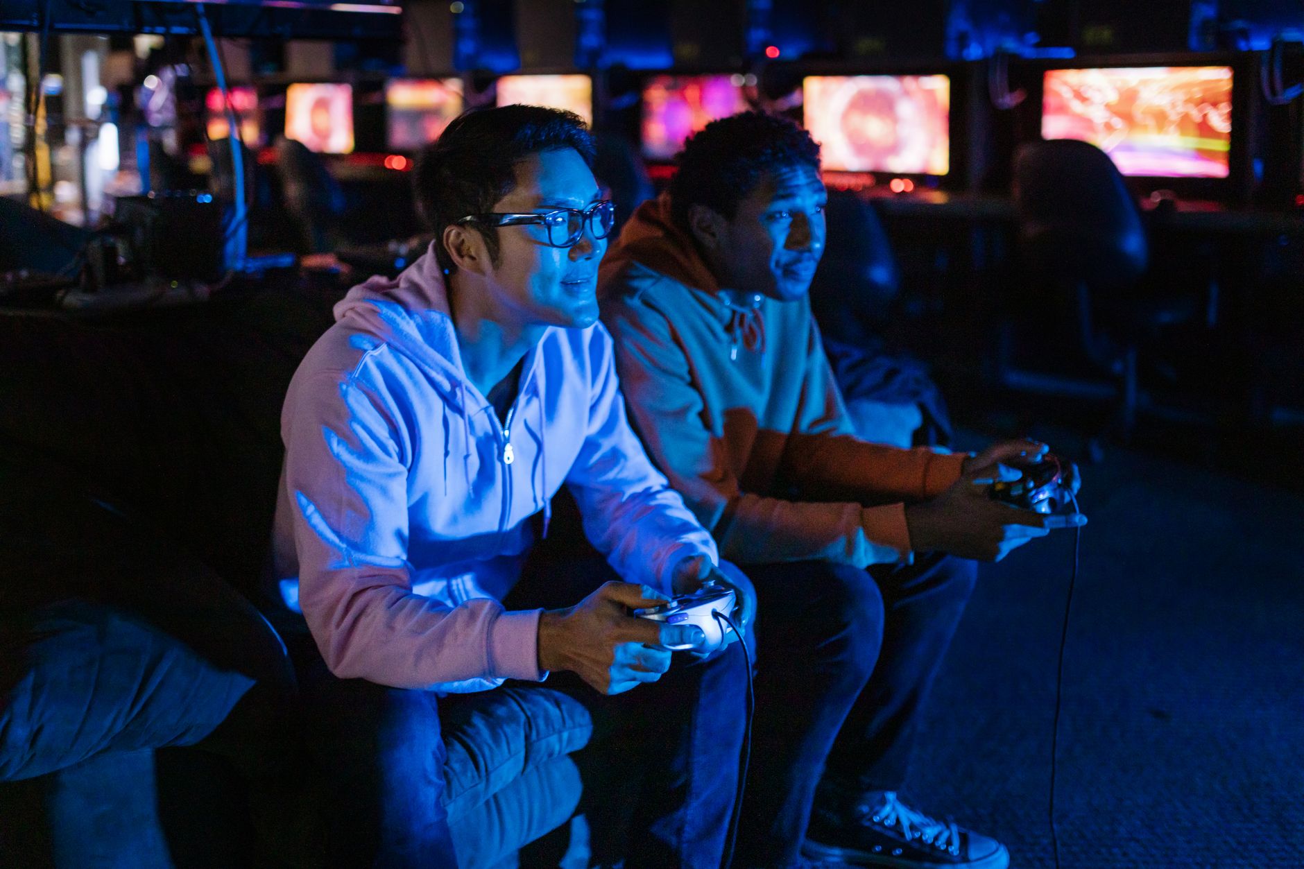 A person playing a video game late at night with a keyboard and mouse