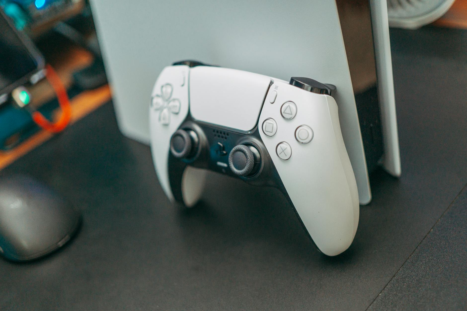 Gaming controller resting on a desk, representing player choice between competing video game titles