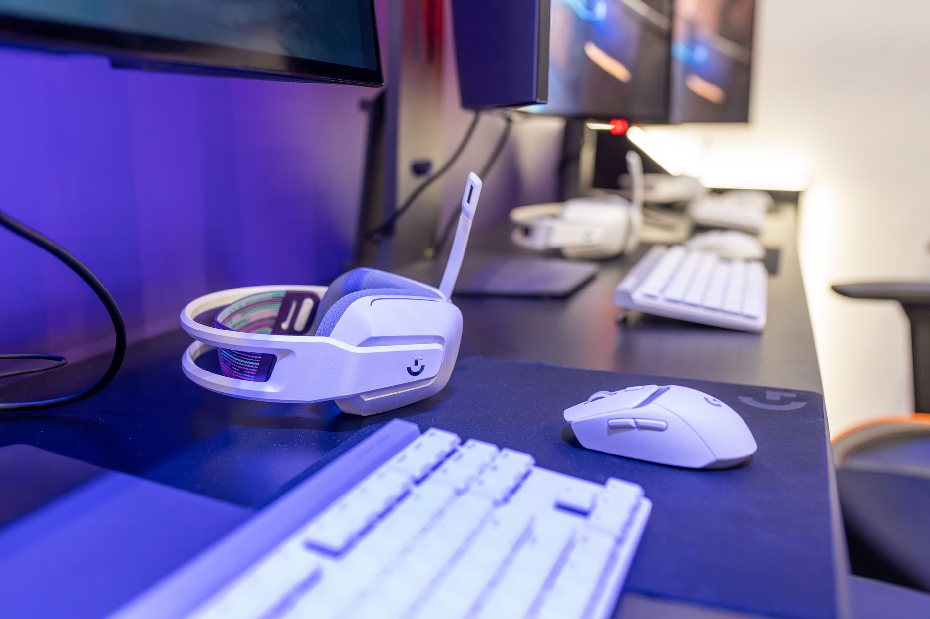 A gaming setup with multiple monitors and peripherals at a player's desk