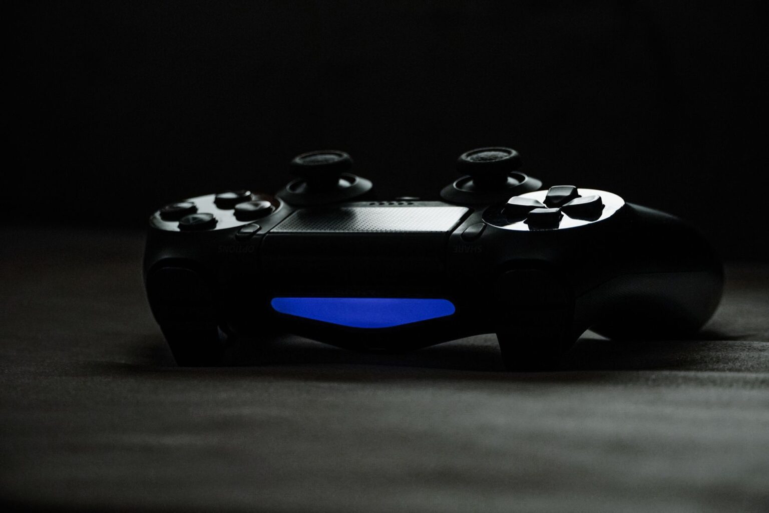 A gaming controller resting on a dark surface, symbolizing the long wait for new game announcements