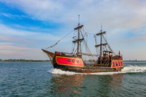 A sailing ship on the open ocean, evoking the naval adventure of Assassin's Creed Black Flag