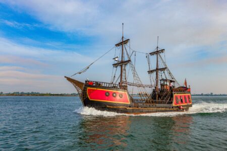 A sailing ship on the open ocean, evoking the naval adventure of Assassin's Creed Black Flag