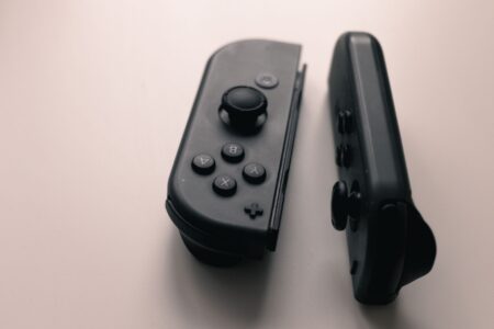 Konami’s Silent Hill 2 Remake Success Is Shelving Bloober’s Other Work A game controller resting near a dark atmospheric screen, evoking survival horror gameplay