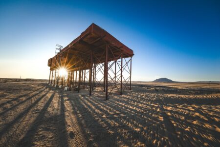 A desolate wasteland scene evoking the post-apocalyptic setting of the Fallout game series