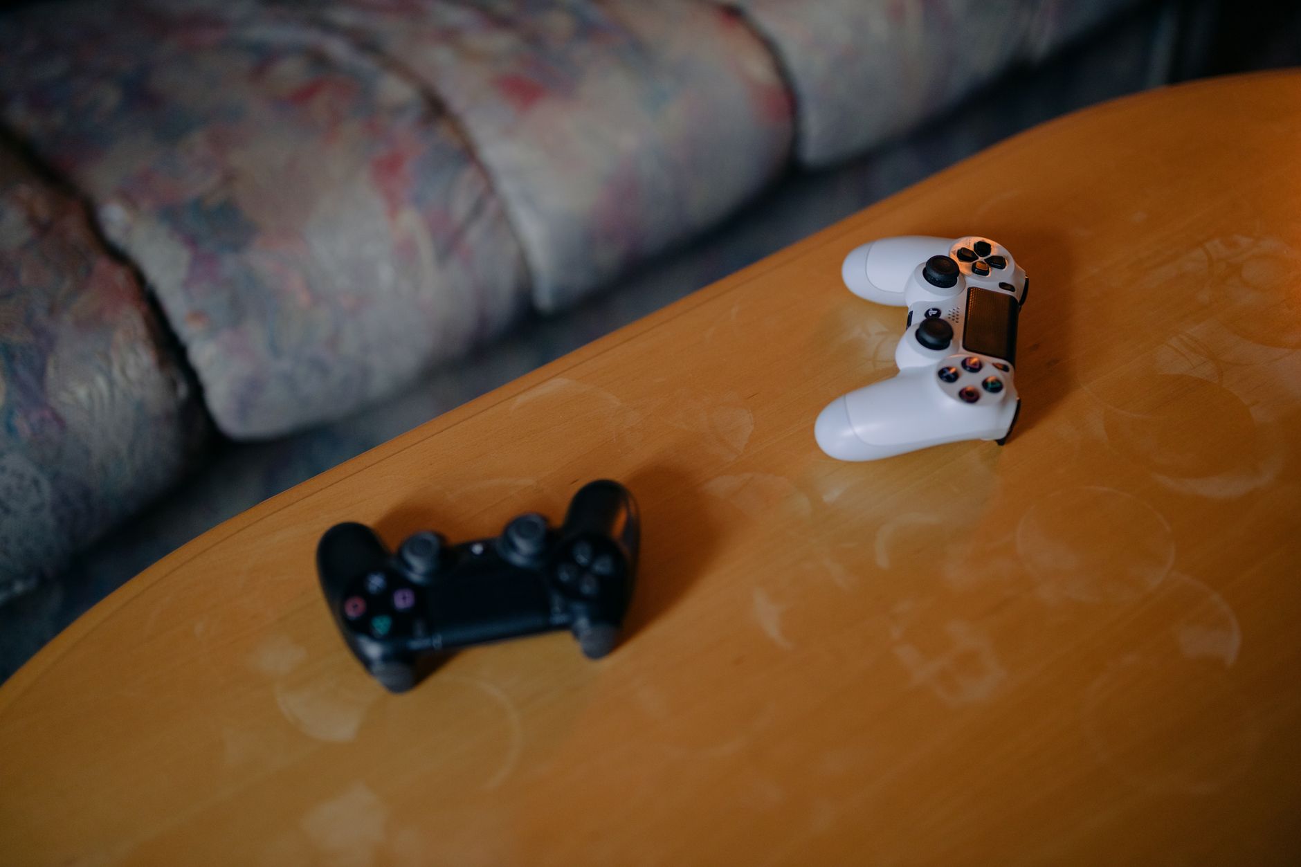 Person relaxing on a couch holding a game controller, representing casual gaming fatigue