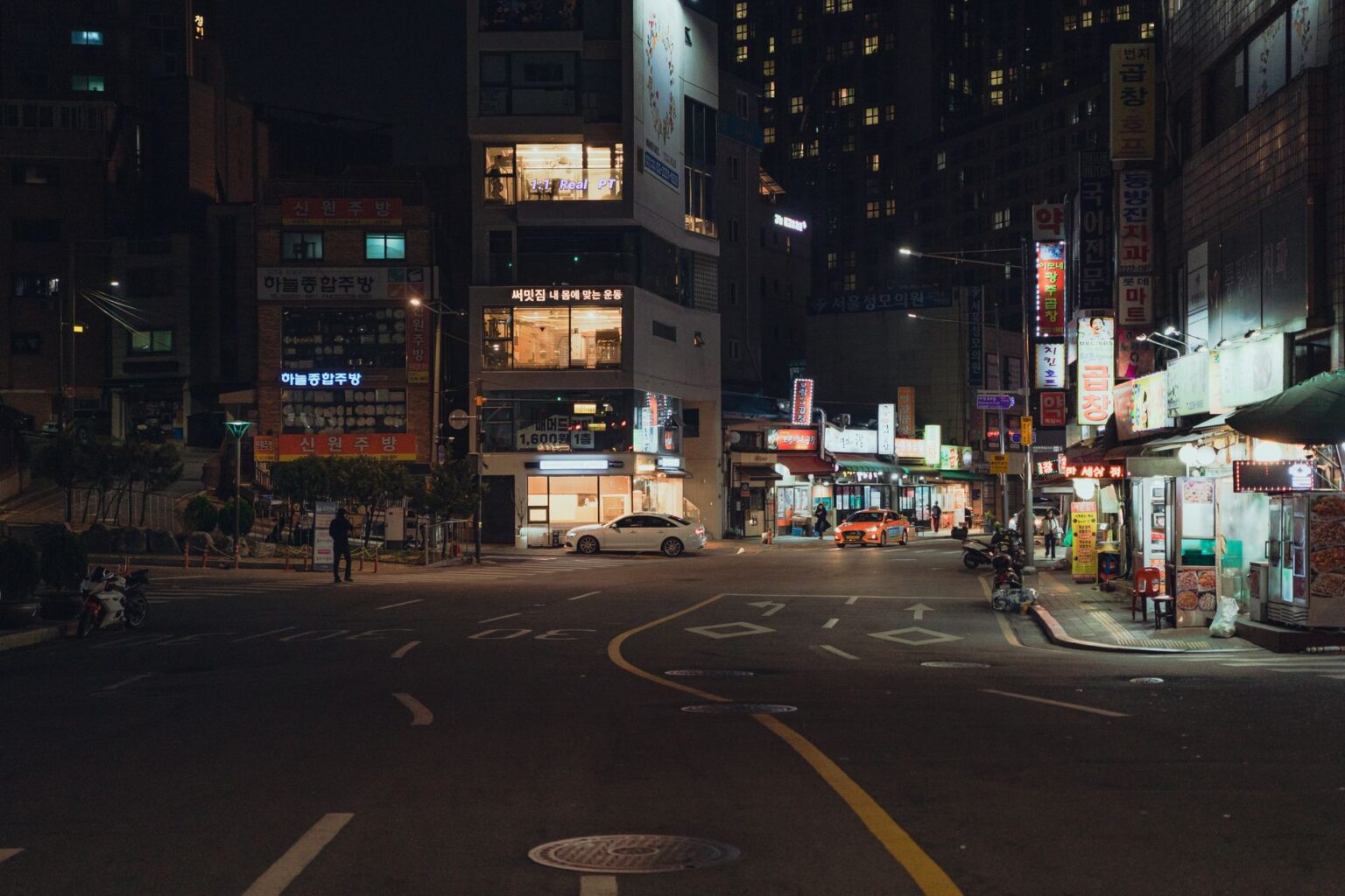 Neon-lit urban street at night evoking a retro Miami aesthetic similar to GTA Vice City