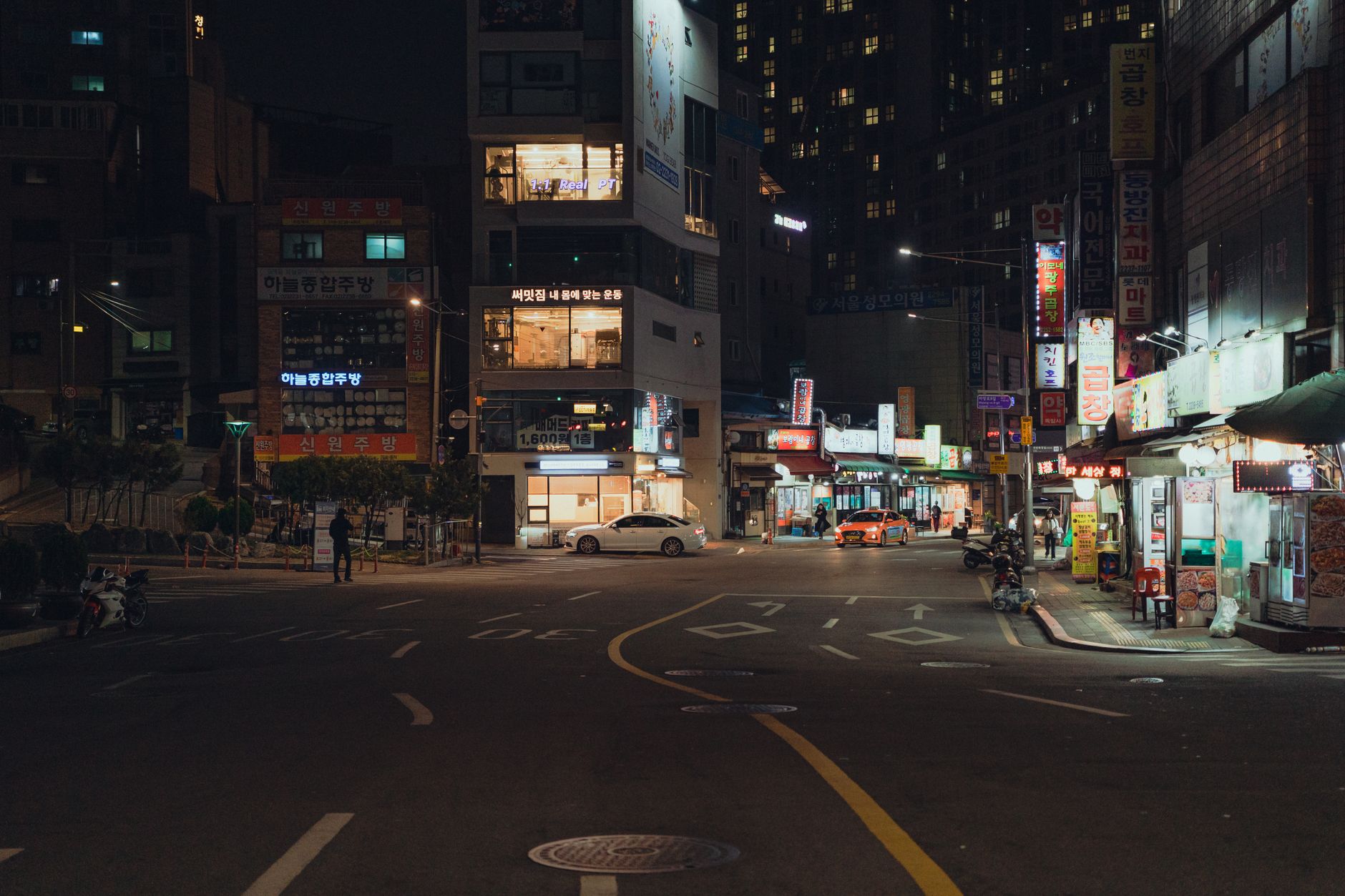 Neon-lit urban street at night evoking a retro Miami aesthetic similar to GTA Vice City
