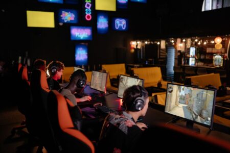 Player focused on a competitive strategy game on a monitor at a gaming desk