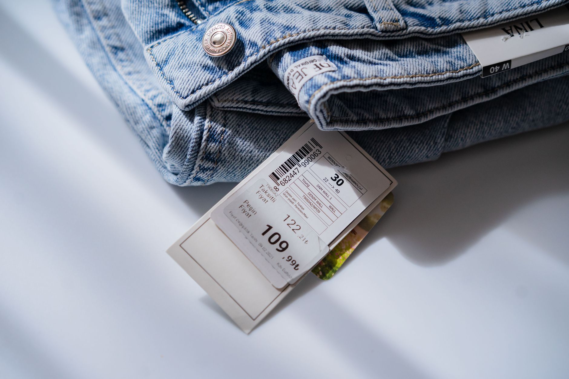 A price tag on a retail shelf, representing product discounting and value perception