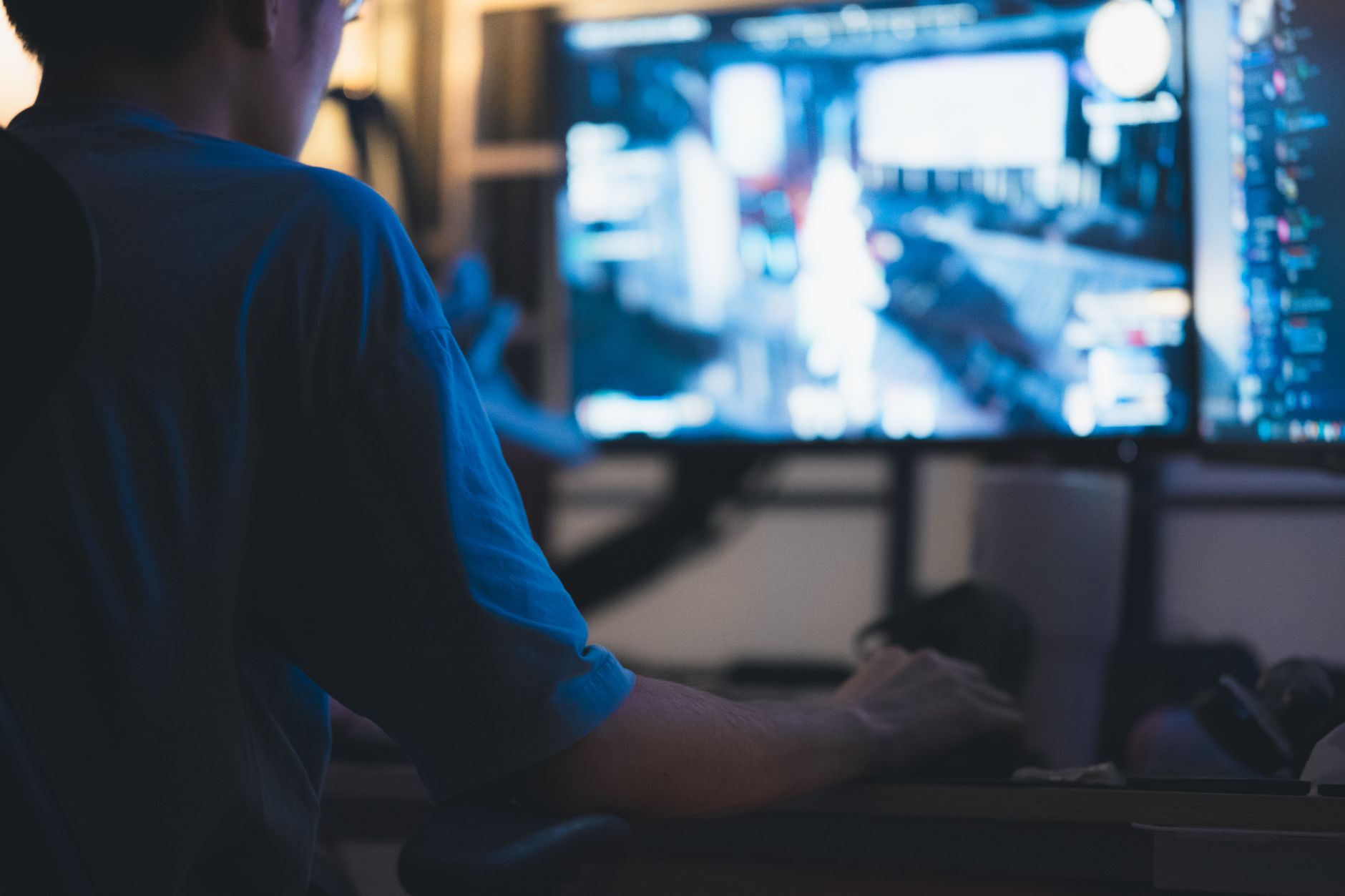 A game developer working at a computer terminal during video game production