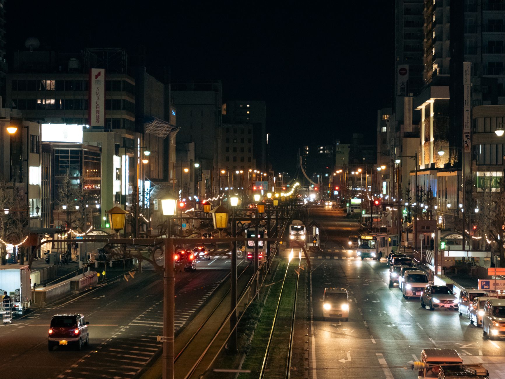 Busy city street at night with neon signs, evoking the urban atmosphere of the Yakuza game series
