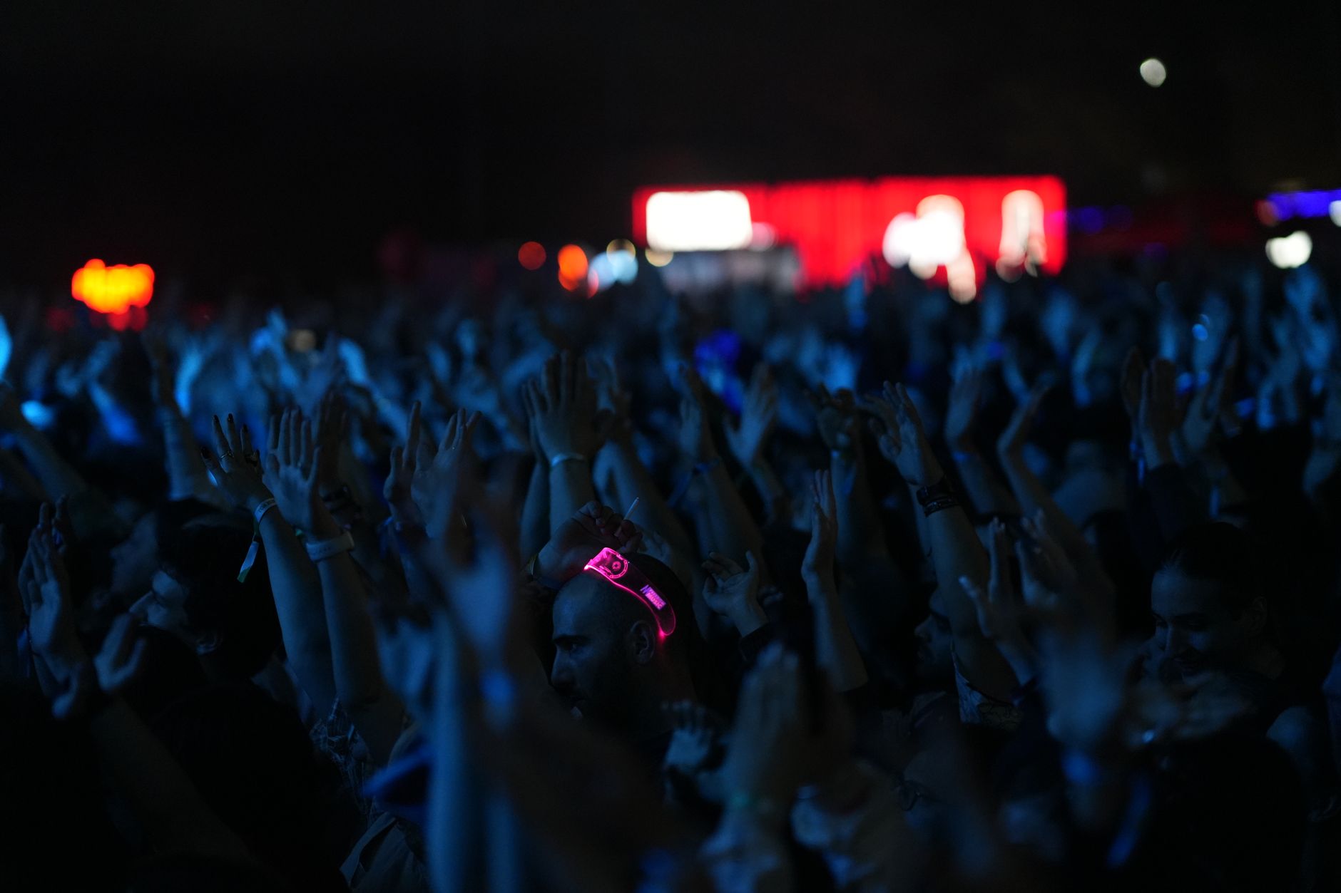 A concert crowd with colorful stage lighting, evoking the music and performance energy central to rhythm games