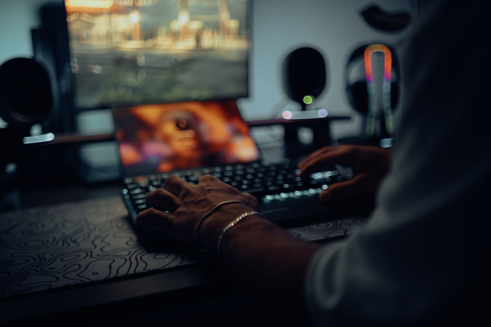 Game development studio workspace with screens and concept art on walls