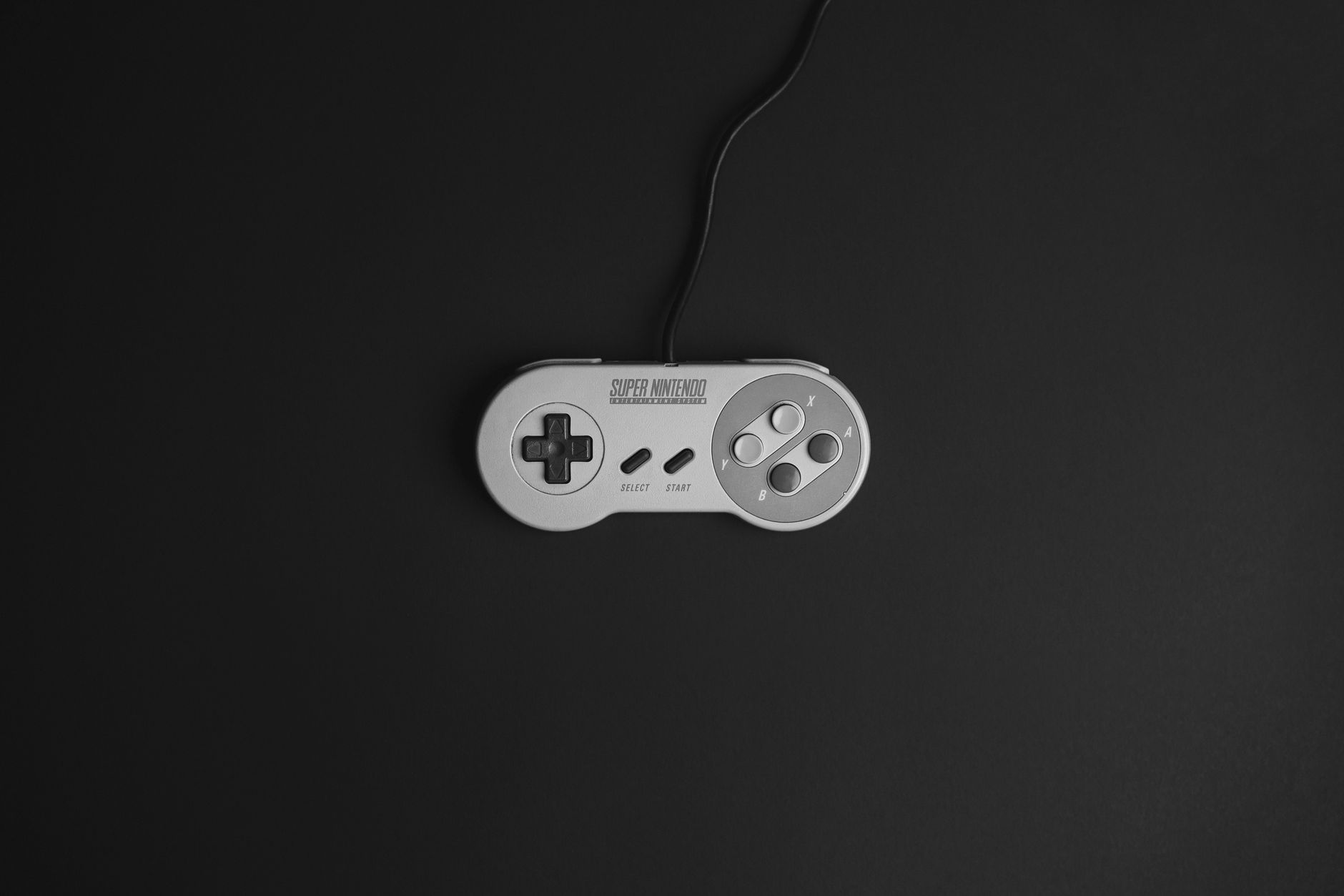 A game controller resting on a dark surface, symbolizing player engagement and choice