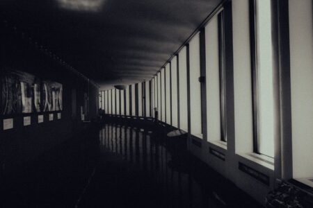 A dimly lit, fog-filled hallway evoking the atmosphere of a horror game environment