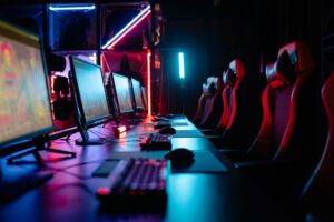 A dark gaming setup with a glowing monitor, representing intense gaming sessions in Monster Hunter Wilds