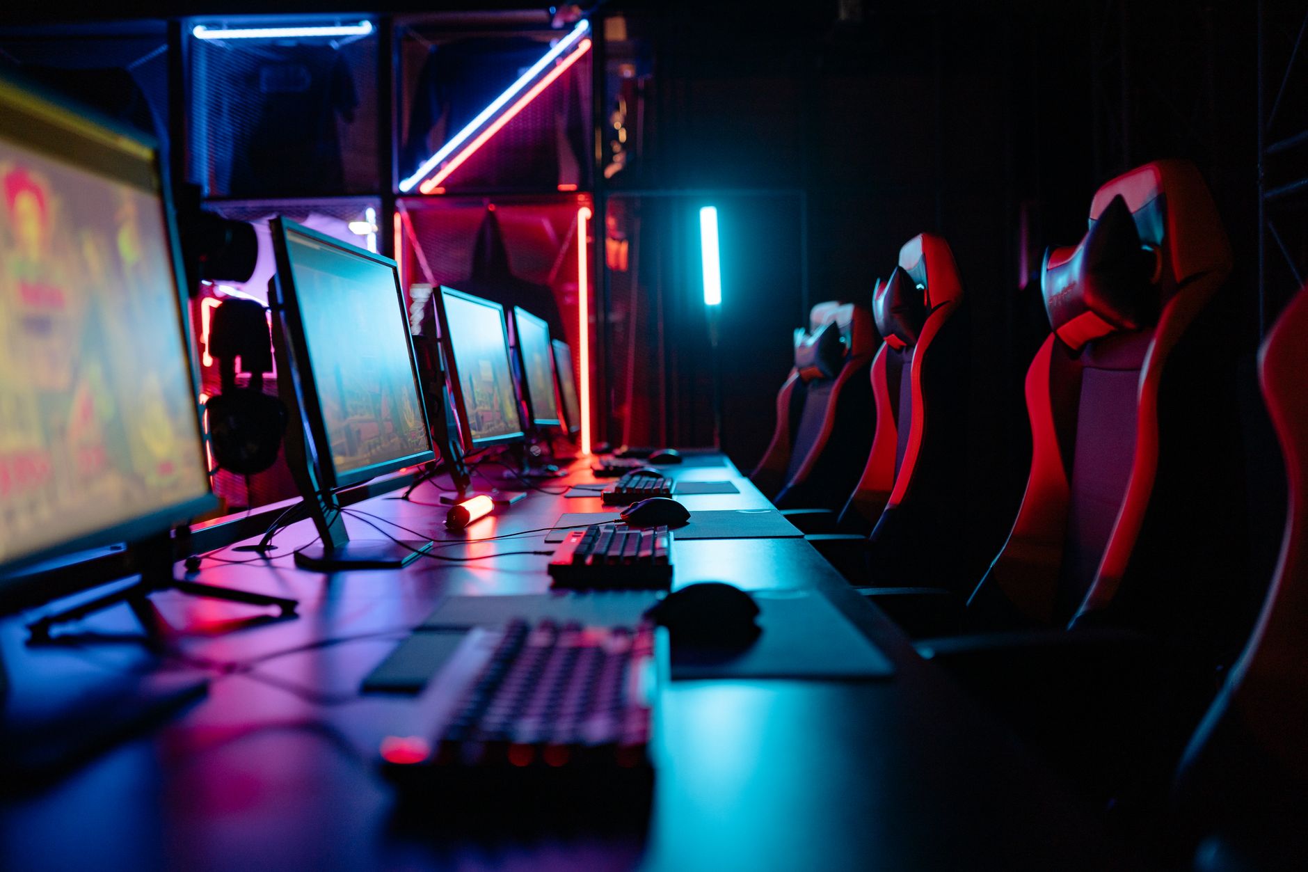 A dark gaming setup with a glowing monitor, representing intense gaming sessions in Monster Hunter Wilds