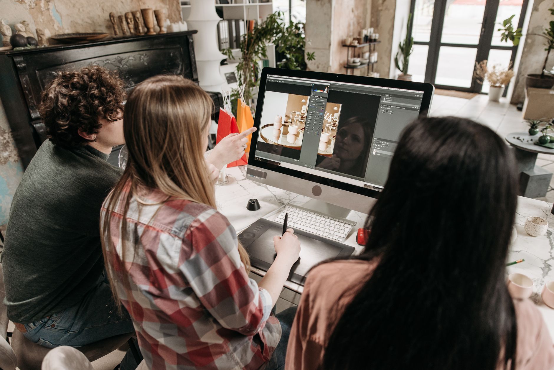 Game developers collaborating at workstations in a dimly lit studio environment
