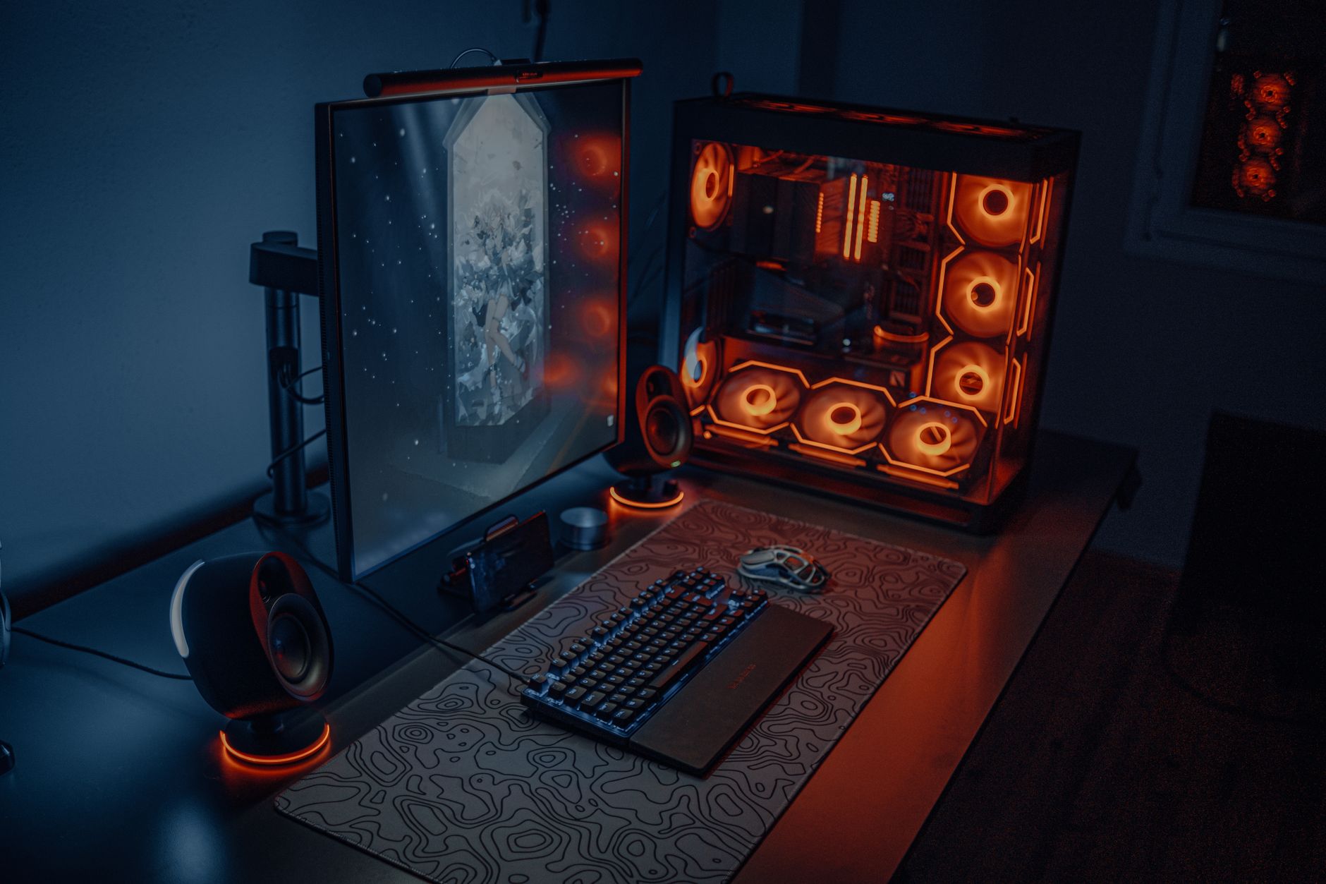 A gaming PC setup with keyboard, monitor, and peripherals on a desk