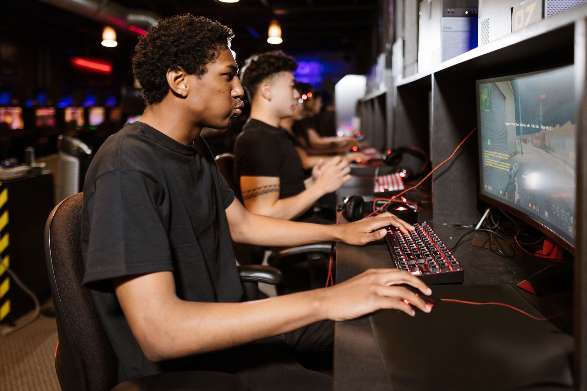 A person playing a computer game, representing a player returning to a shelved title