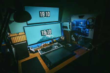A gaming PC setup with a monitor displaying a competitive multiplayer game