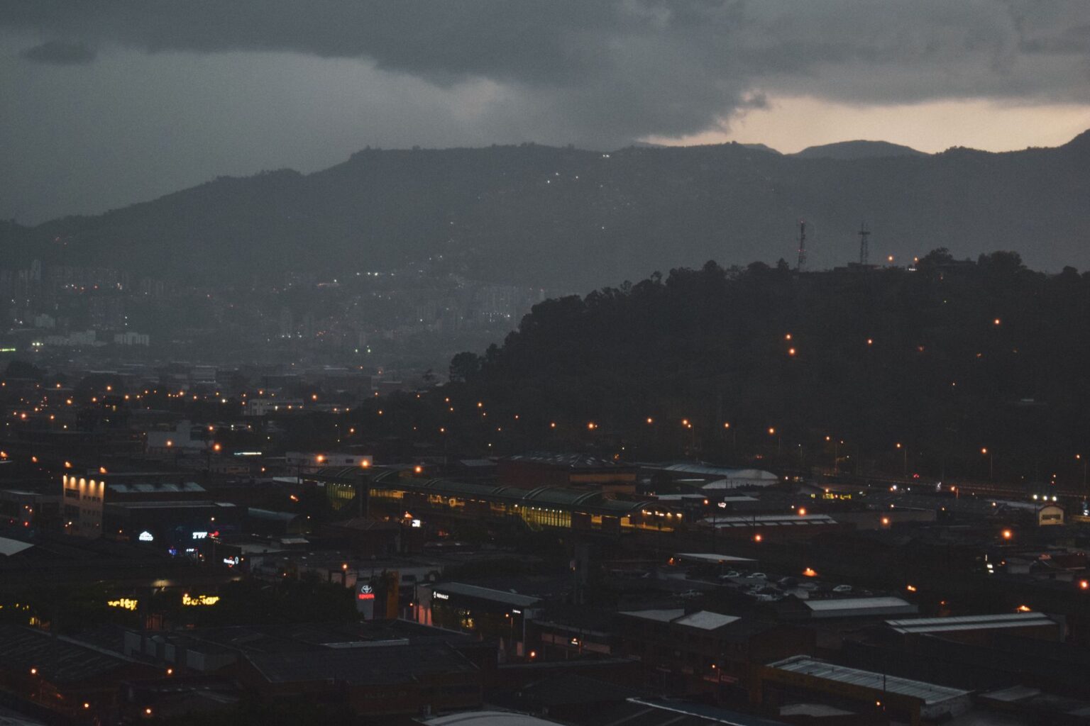 Dark urban cityscape at night evoking an abandoned post-apocalyptic atmosphere