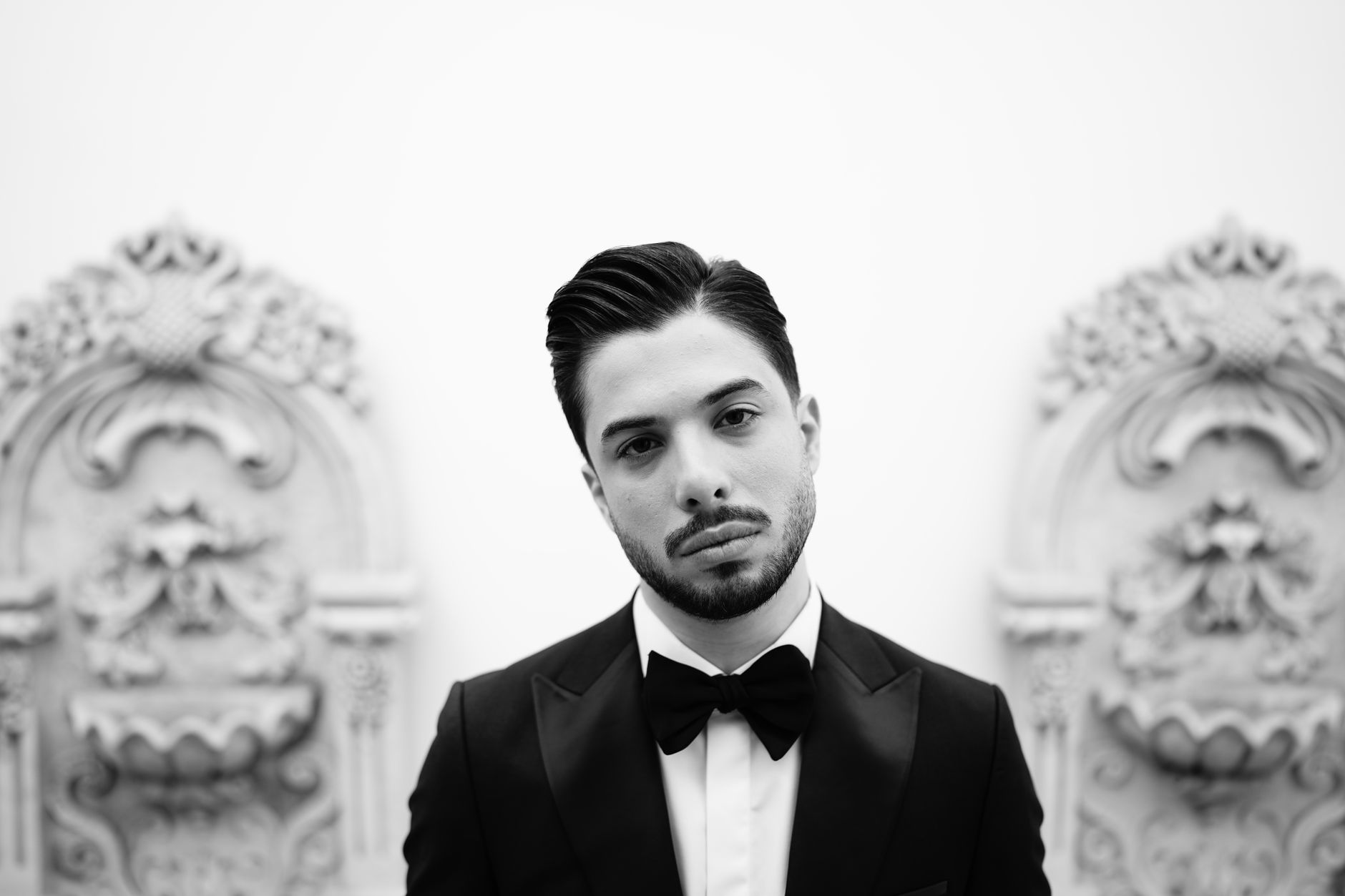 Man in a formal black tuxedo, referencing the classic James Bond visual style